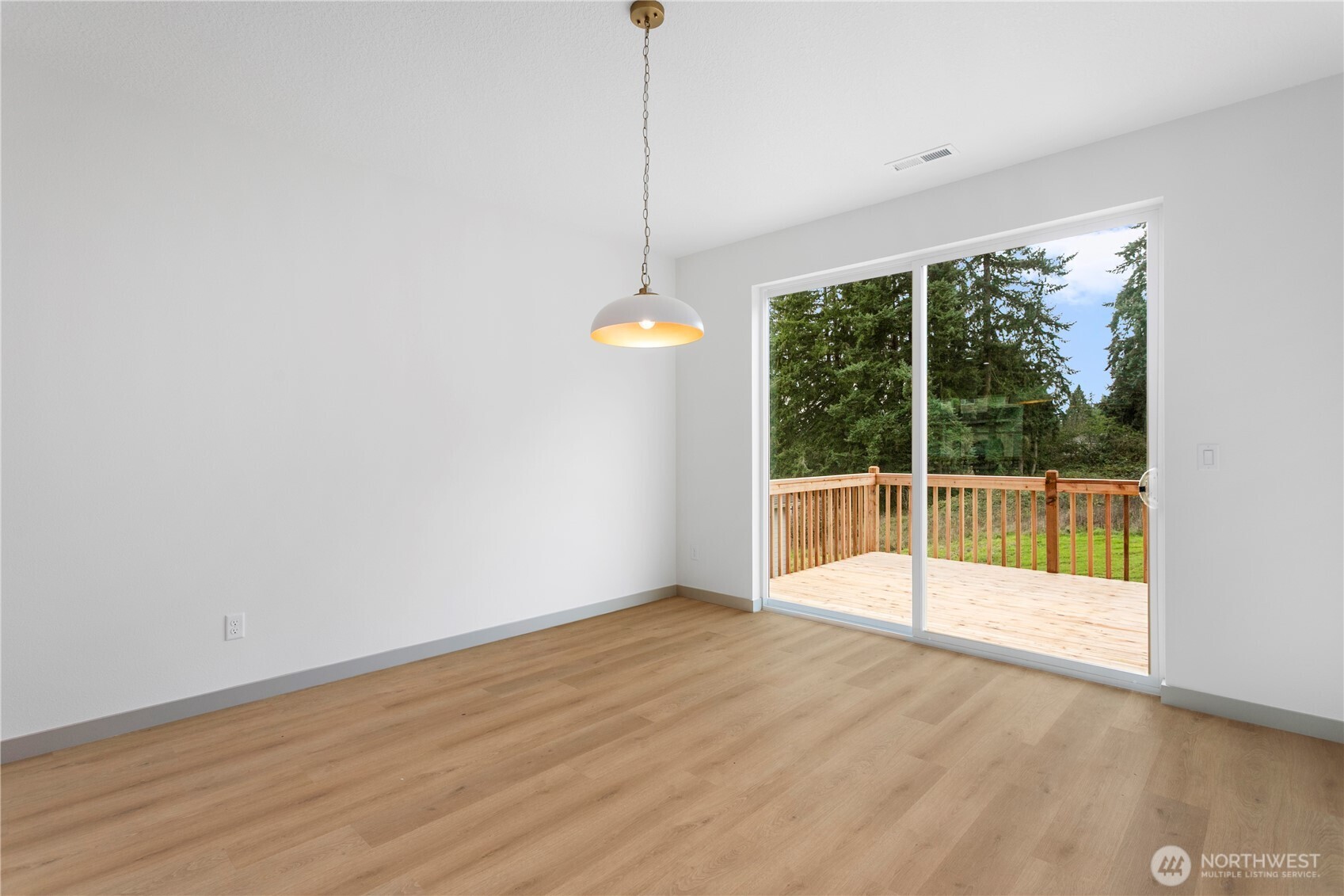 2333 West Castleman Street Longview, WA 98632 - Photo 13 of 39 a view of an empty room with wooden floor and windows