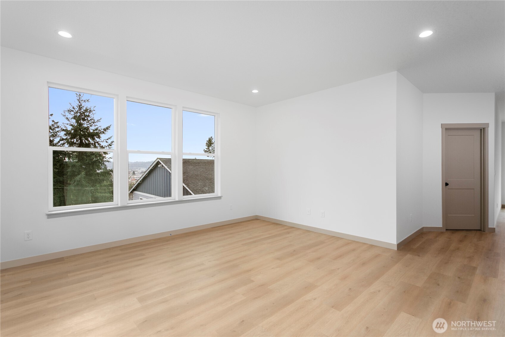 2333 West Castleman Street Longview, WA 98632 - Photo 6 of 39 a view of an empty room with a window and wooden floor