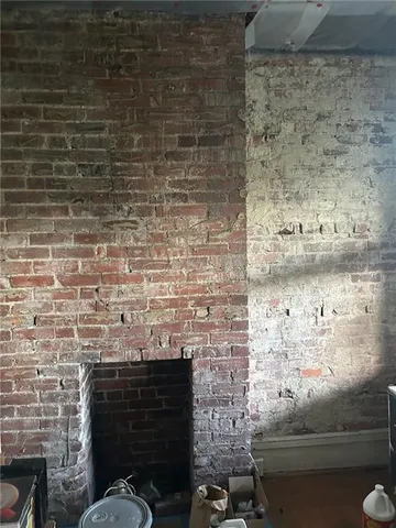 a living room with furniture a fireplace and a chandelier