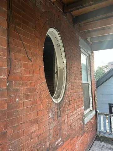 a bathroom with a brick wall and a stove
