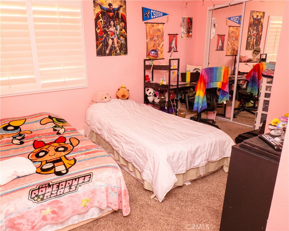 2831 Carma Court Riverside, CA 92503 - Photo 15 of 20 a bed room with a bed and a baby bed