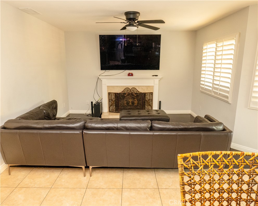 2831 Carma Court Riverside, CA 92503 - Photo 7 of 20 a living room with furniture a flat screen tv and a fireplace