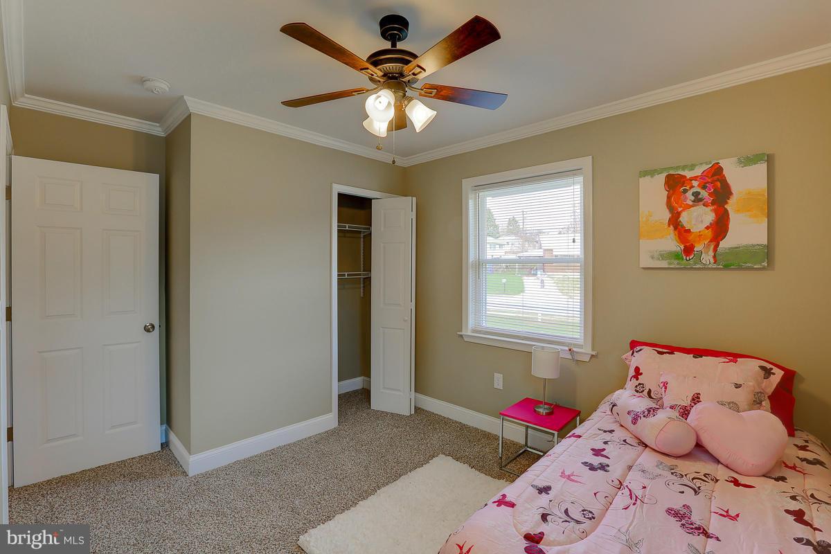 144 Embleton Road Owings Mills, MD 21117 - Photo 11 of 26 a bedroom with a bed and a chandelier