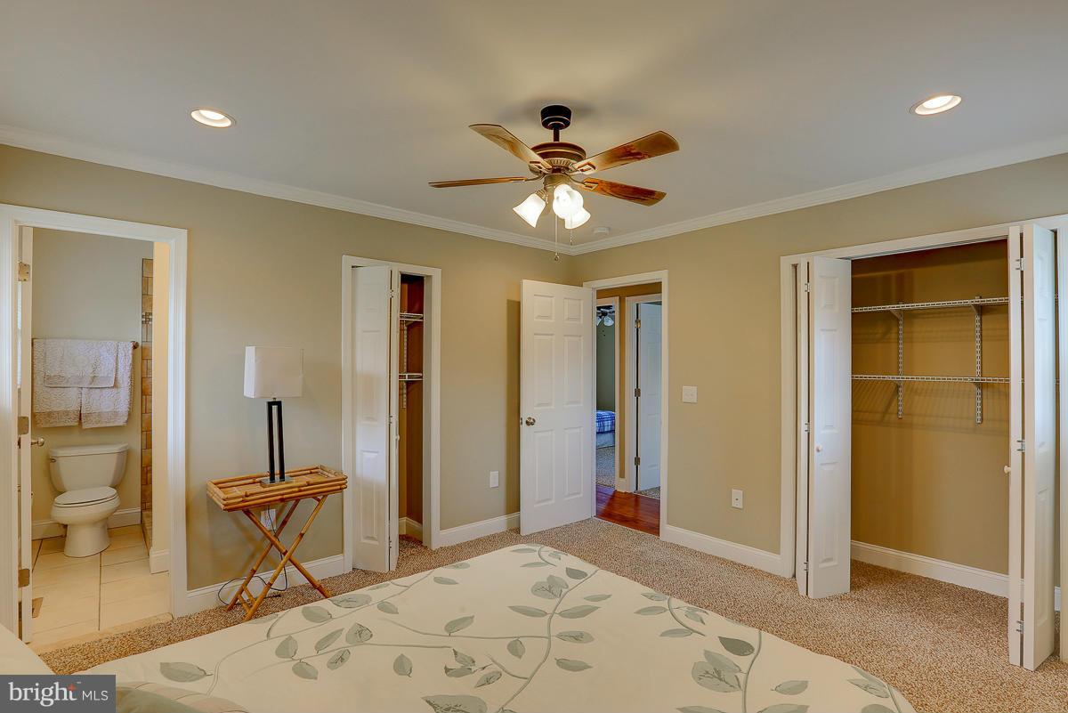 144 Embleton Road Owings Mills, MD 21117 - Photo 13 of 26 a bedroom with a bed and a chandelier