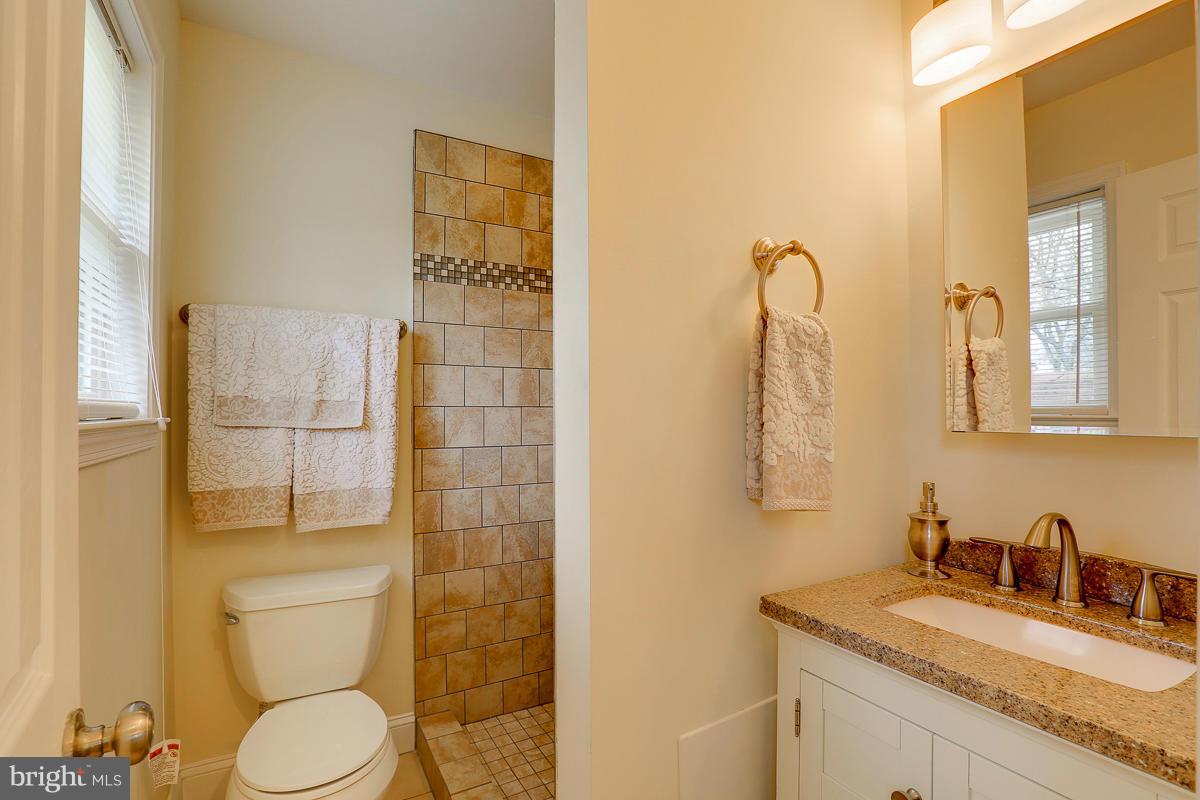 144 Embleton Road Owings Mills, MD 21117 - Photo 14 of 26 a bathroom with a granite countertop sink toilet and shower