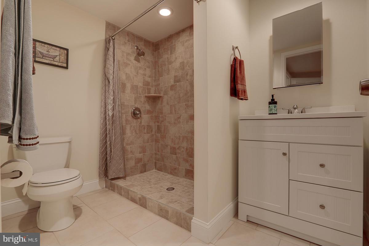 144 Embleton Road Owings Mills, MD 21117 - Photo 17 of 26 a bathroom with a shower sink and mirror