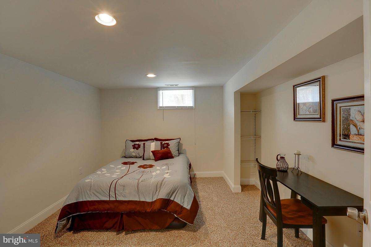 144 Embleton Road Owings Mills, MD 21117 - Photo 18 of 26 a bedroom with a bed and a chair