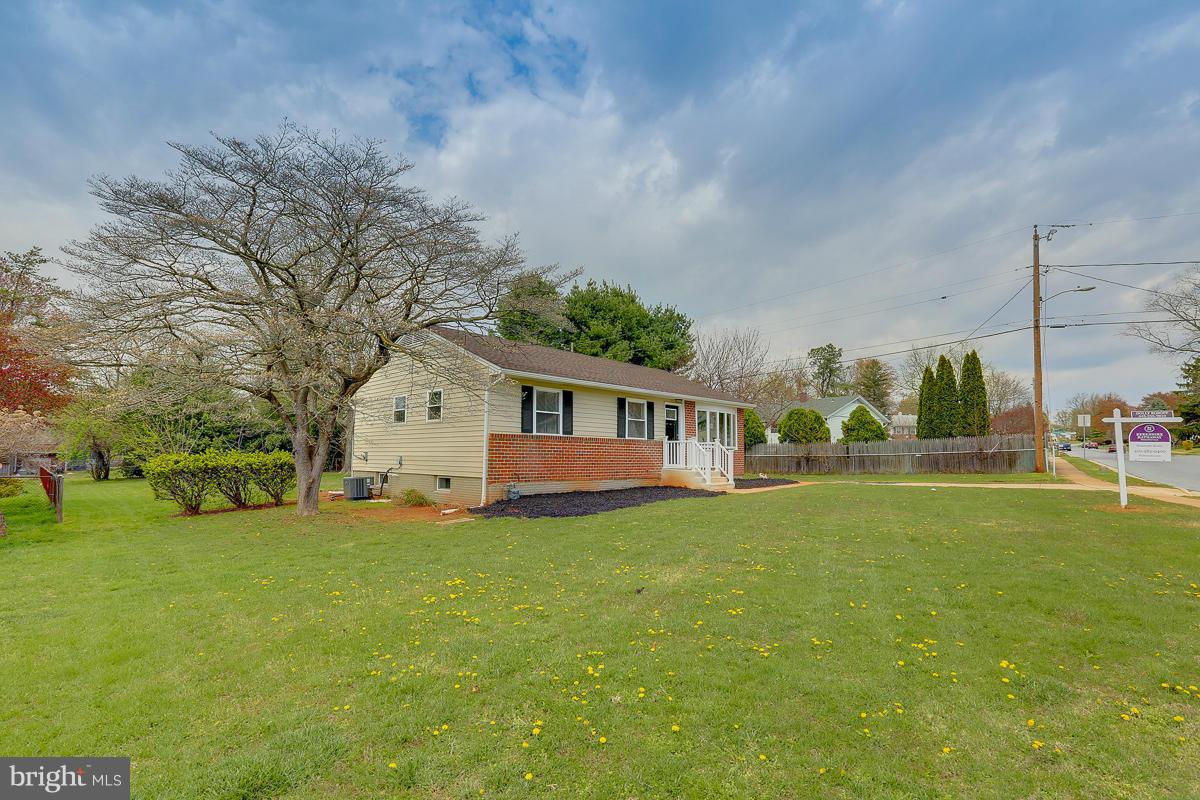 144 Embleton Road Owings Mills, MD 21117 - Photo 22 of 26 a view of a house with a big yard and large trees