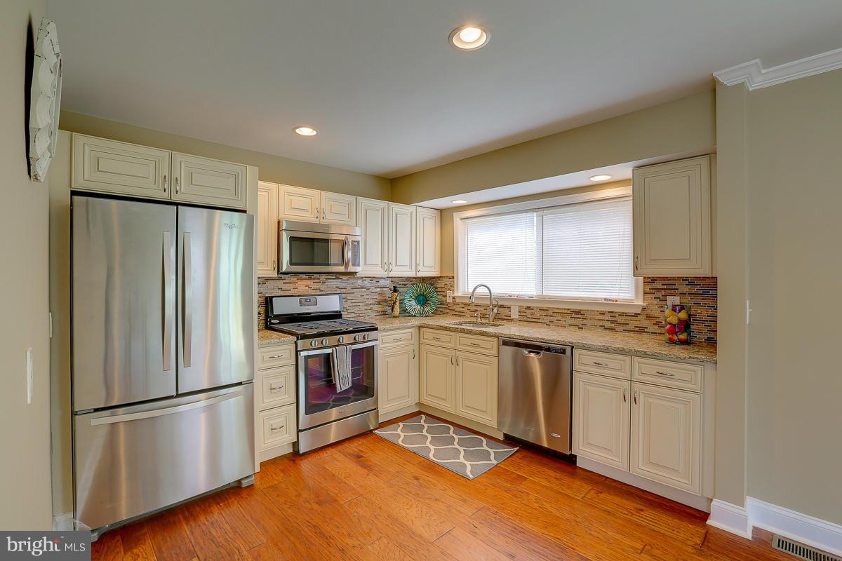 144 Embleton Road Owings Mills, MD 21117 - Photo 5 of 26 a kitchen with granite countertop stainless steel appliances a refrigerator sink and microwave