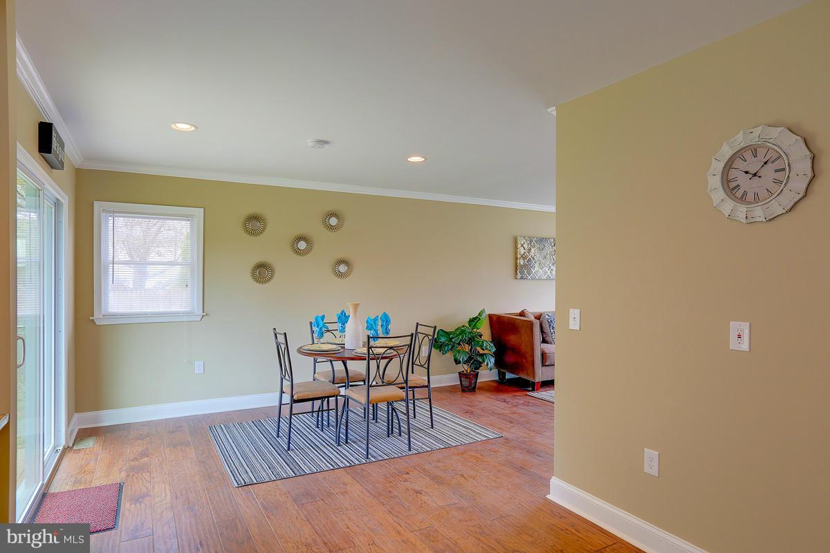 144 Embleton Road Owings Mills, MD 21117 - Photo 7 of 26 a workspace with furniture and wooden floor