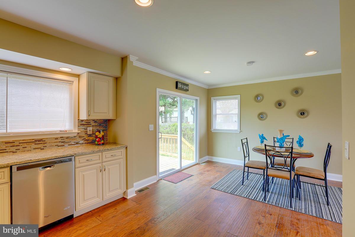 144 Embleton Road Owings Mills, MD 21117 - Photo 8 of 26 a view of a kitchen area with furniture and wooden floor