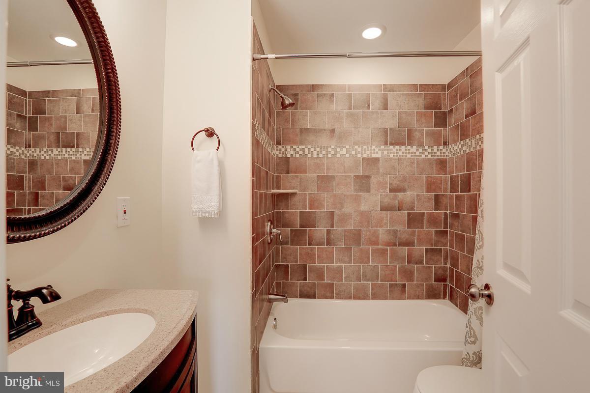 144 Embleton Road Owings Mills, MD 21117 - Photo 10 of 26 a bathroom with a sink a bathtub and a mirror