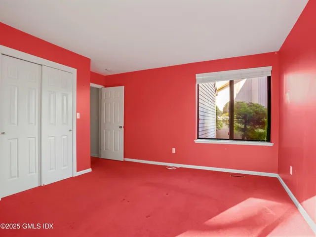 a view of a room with a window and a ceiling fan