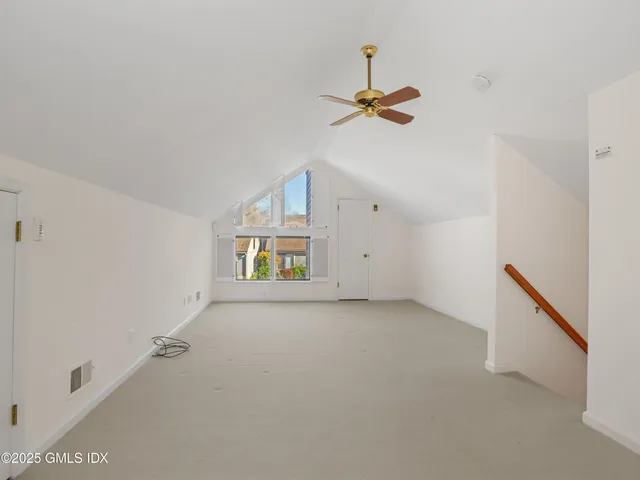a view of hallway with stairs and a window