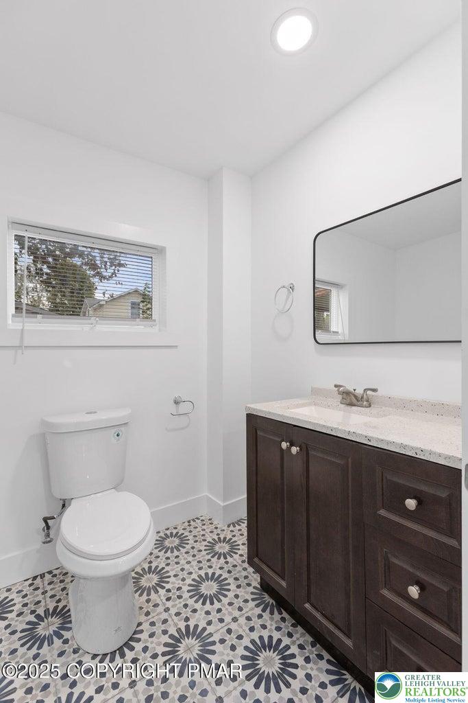 210 Fowler Street Berwick, PA 18603 - Photo 12 of 24 a bathroom with a toilet a sink and mirror