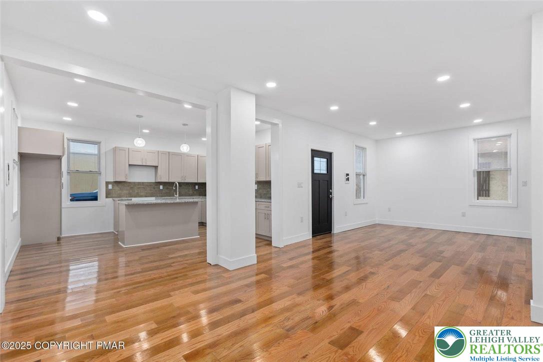 210 Fowler Street Berwick, PA 18603 - Photo 2 of 24 a view of kitchen with kitchen island granite countertop white cabinets and refrigerator