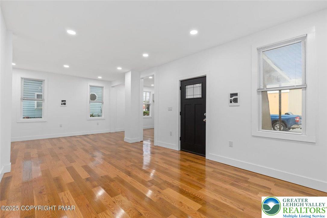 210 Fowler Street Berwick, PA 18603 - Photo 6 of 24 a view of an empty room with wooden floor and a window