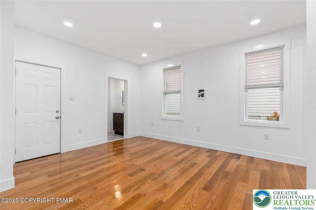 210 Fowler Street Berwick, PA 18603 - Photo 7 of 24 a view of an empty room with wooden floor and a window