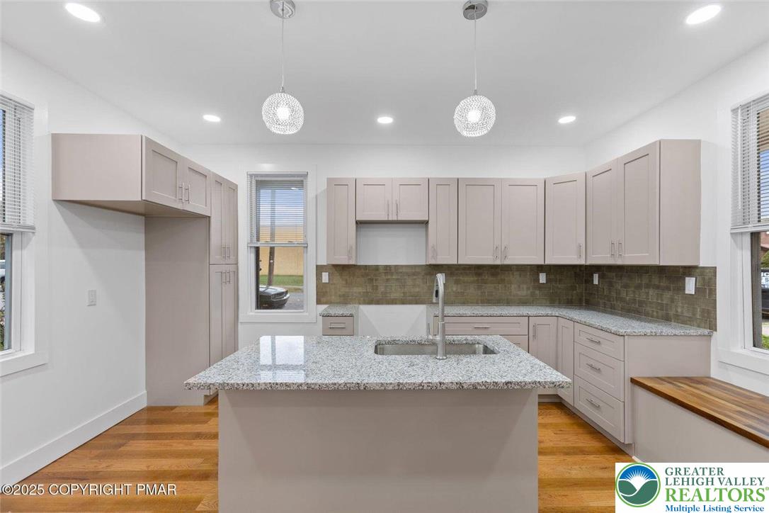 210 Fowler Street Berwick, PA 18603 - Photo 9 of 24 a kitchen with kitchen island granite countertop a sink and refrigerator