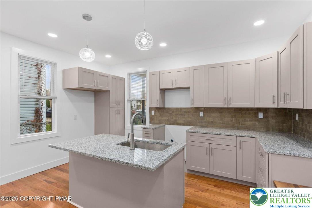 210 Fowler Street Berwick, PA 18603 - Photo 10 of 24 a kitchen with kitchen island granite countertop a sink a stove and cabinets