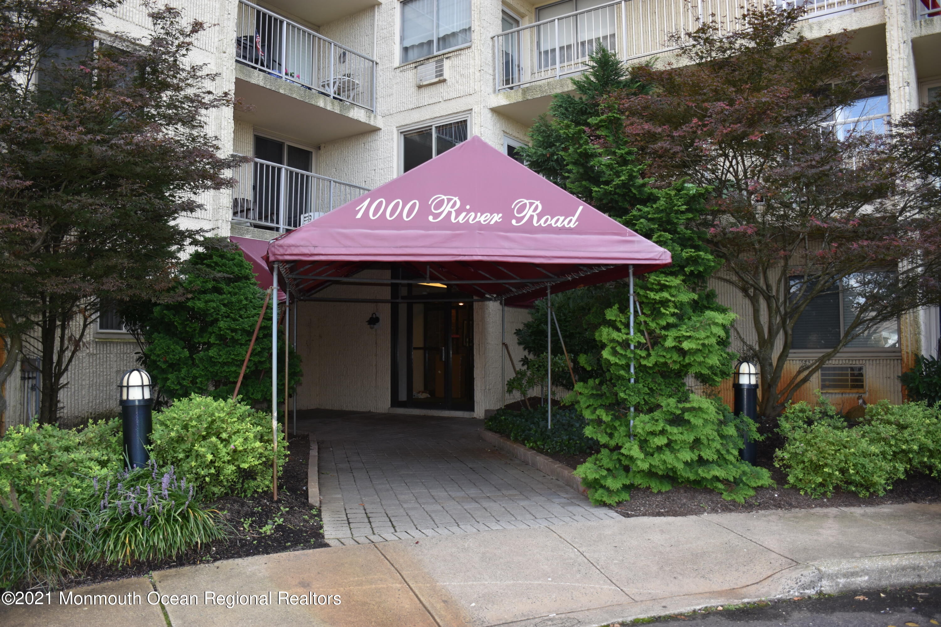 1000 River Road, Unit 3J Belmar, NJ 07719 - Photo 2 of 19 a front view of a building with garden