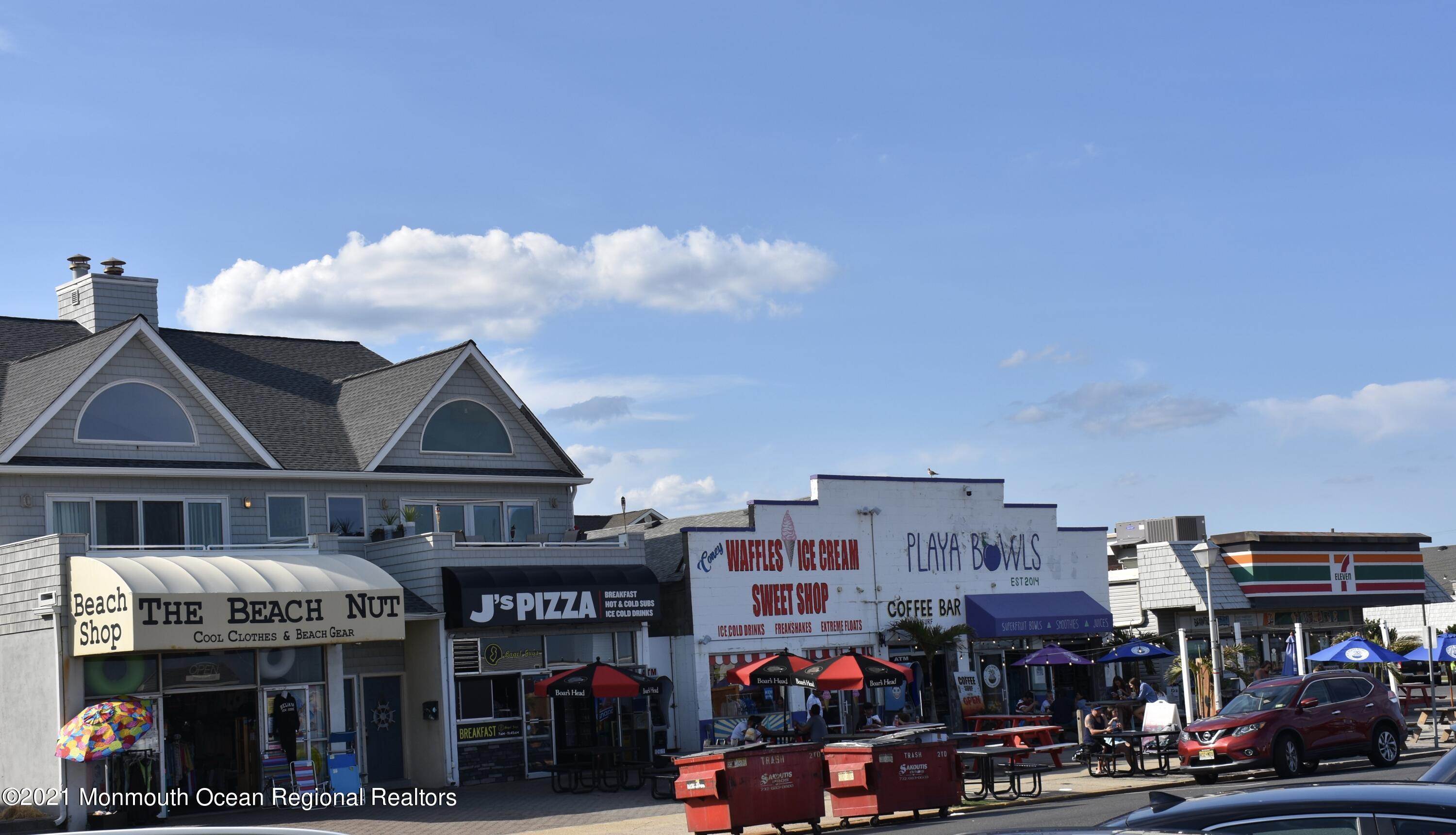 1000 River Road, Unit 3J Belmar, NJ 07719 - Photo 18 of 19 a view of people sitting in front of retail shop