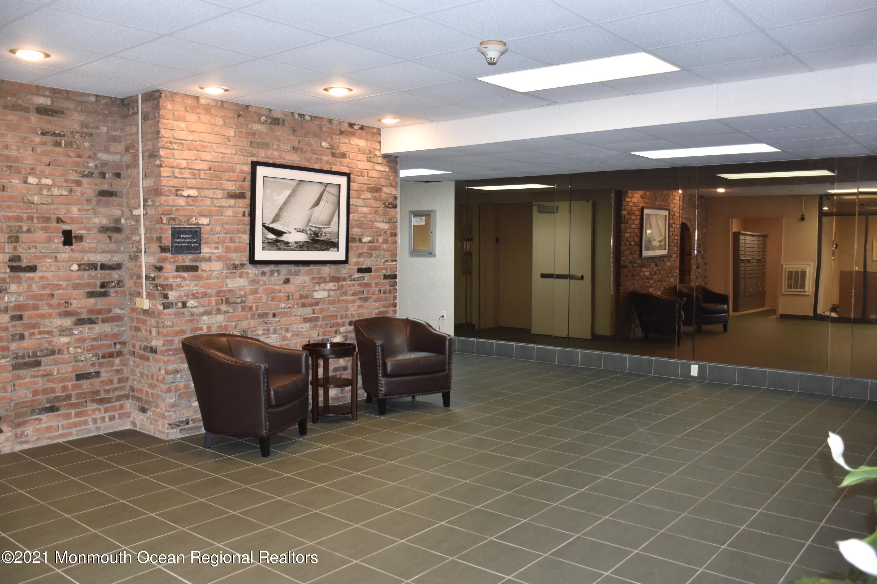 1000 River Road, Unit 3J Belmar, NJ 07719 - Photo 9 of 19 a lobby with furniture and a potted plant
