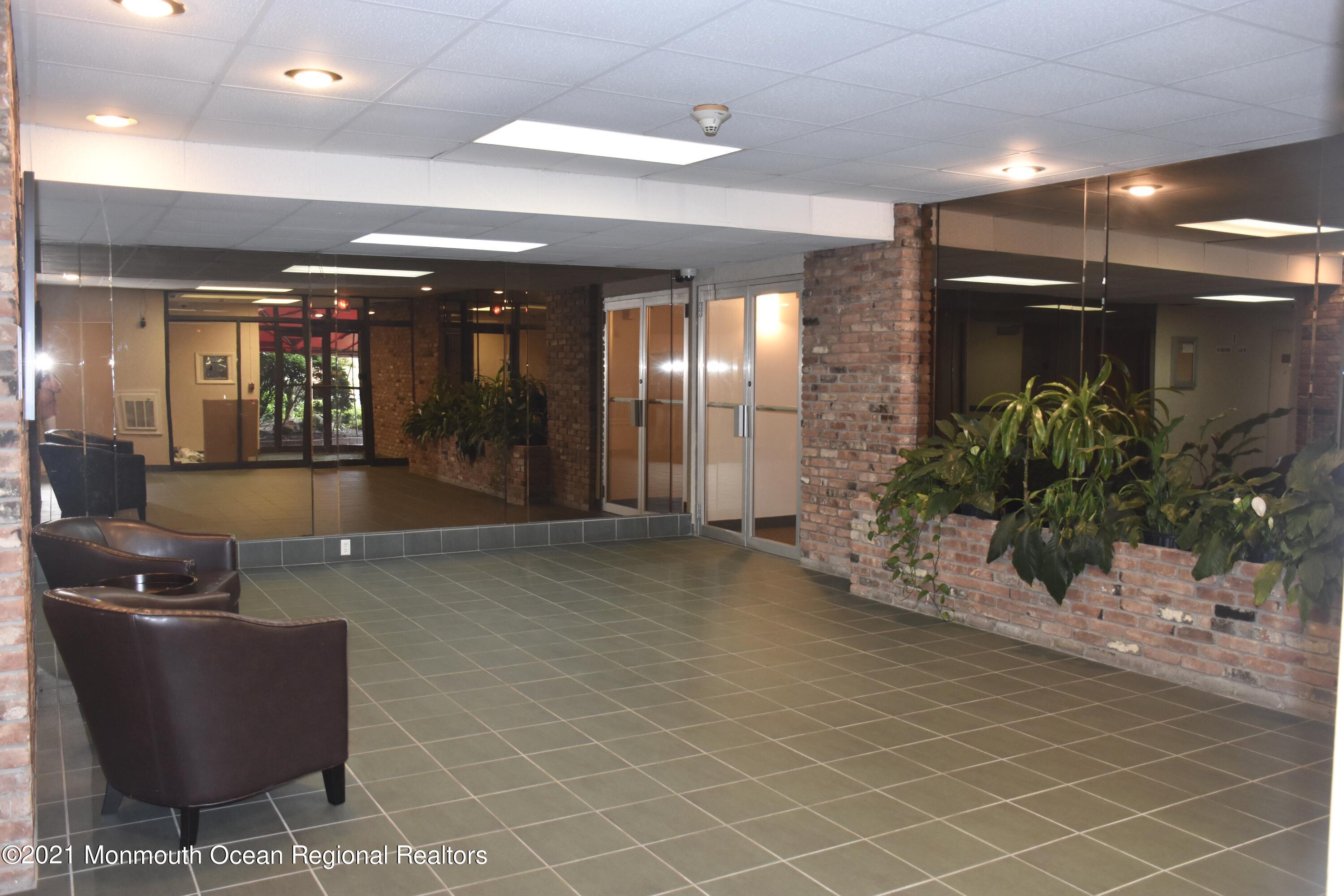 1000 River Road, Unit 3J Belmar, NJ 07719 - Photo 10 of 19 a lobby with furniture and window