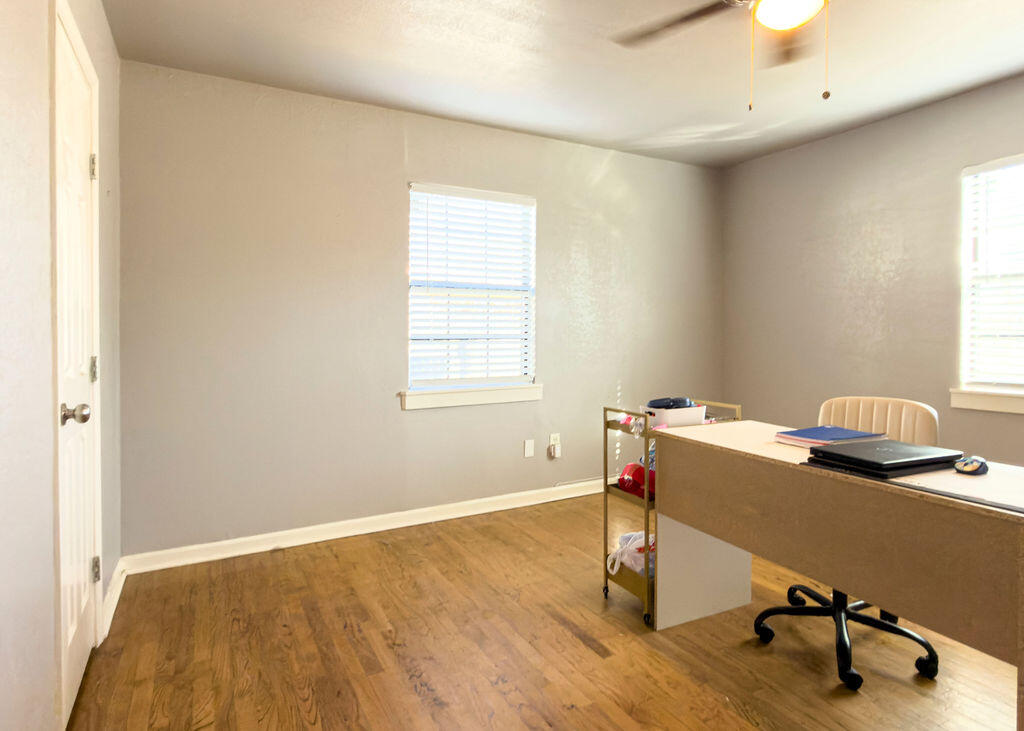 1908 47th Street Lubbock, TX 79412 - Photo 12 of 21 a view of a workspace with furniture and a window