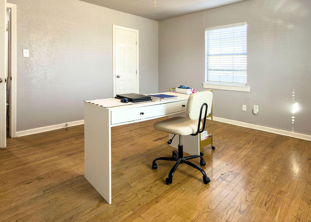 1908 47th Street Lubbock, TX 79412 - Photo 13 of 21 a workspace with wooden floor and a window