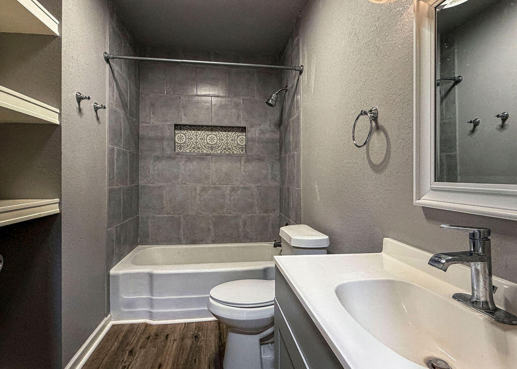 1908 47th Street Lubbock, TX 79412 - Photo 14 of 21 a bathroom with a sink toilet and shower
