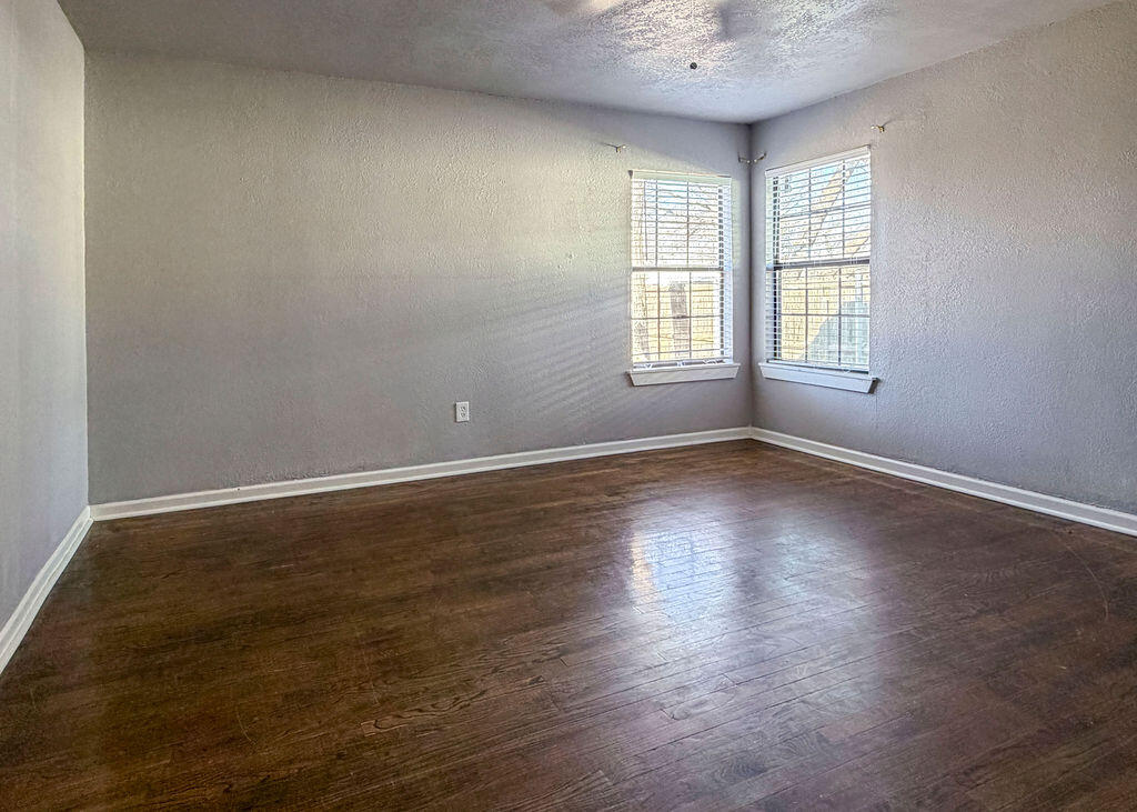 1908 47th Street Lubbock, TX 79412 - Photo 16 of 21 an empty room with wooden floor and windows