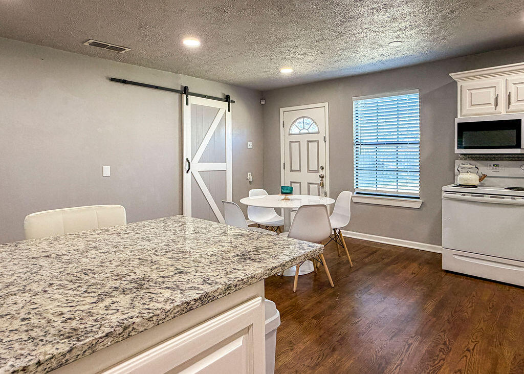 1908 47th Street Lubbock, TX 79412 - Photo 6 of 21 a living room with dining room and wooden floor