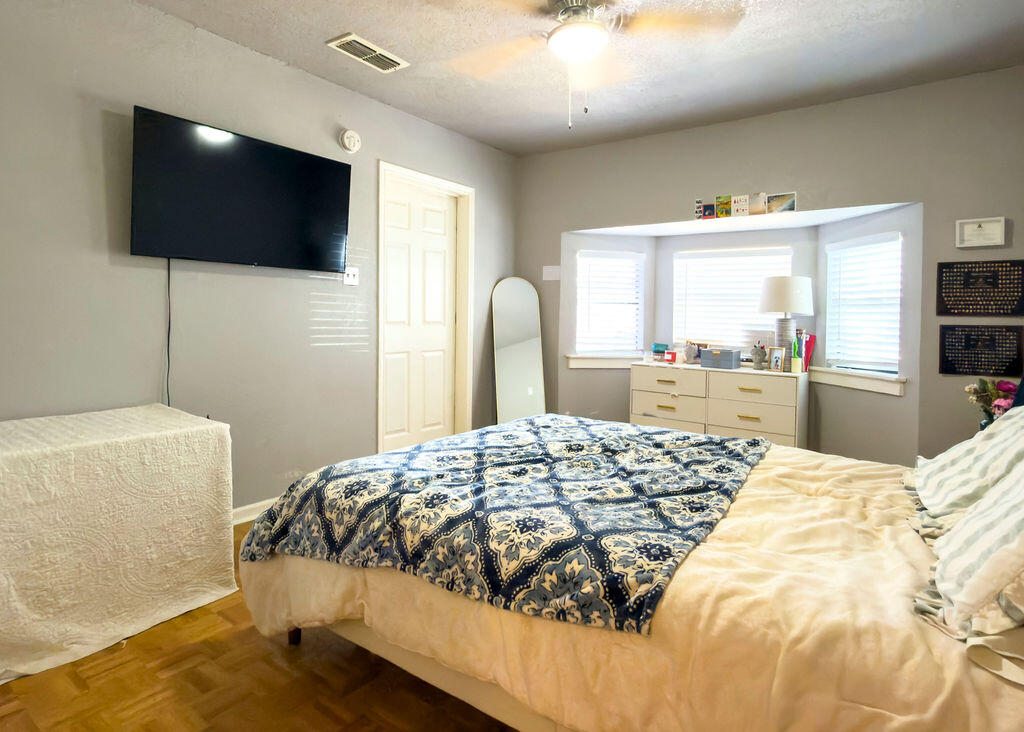 1908 47th Street Lubbock, TX 79412 - Photo 9 of 21 a bedroom with a bed and a flat screen tv