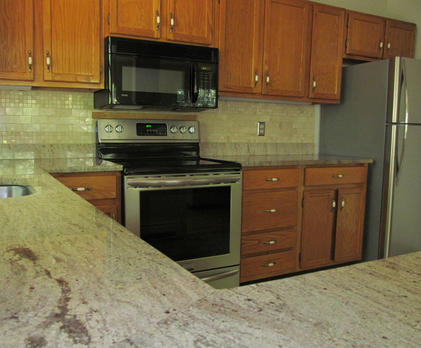 14 Round House Road Bourne, MA 02532 - Photo 7 of 18 a kitchen with stainless steel appliances granite countertop a stove top oven microwave and cabinets