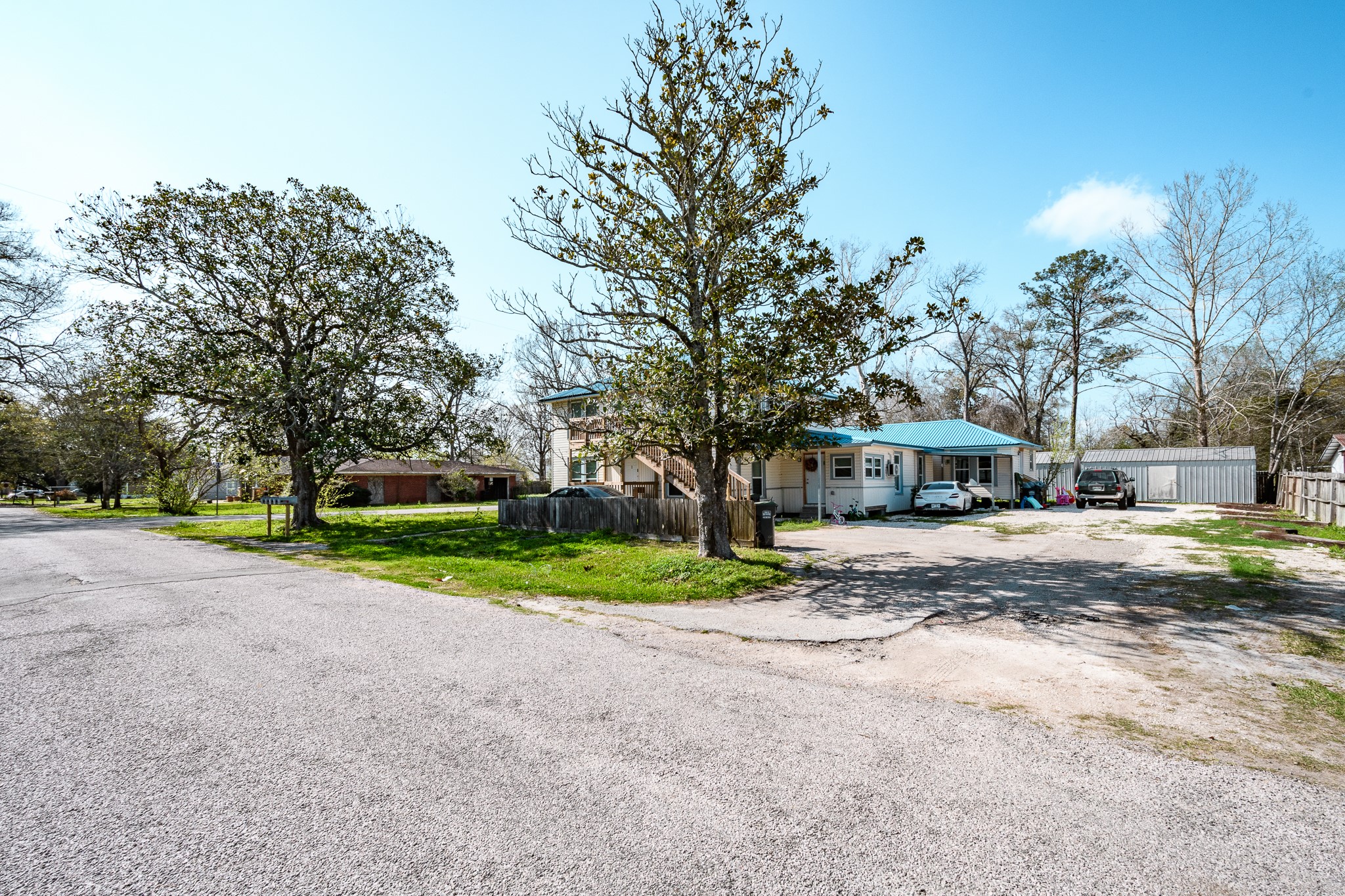 108 West Barrow Street Dayton, TX 77535 - Photo 9 of 18 a view of a house with a yard and large trees