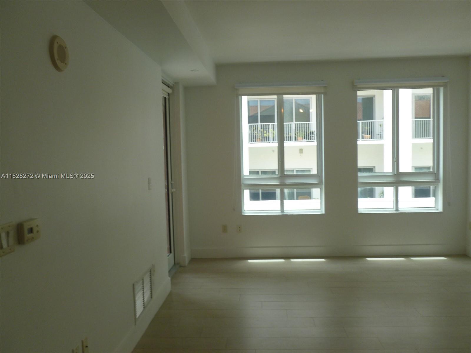 7350 Southwest 89th Street, Unit 808S Miami, FL 33156 - Photo 5 of 13 an empty room with a empty space and windows