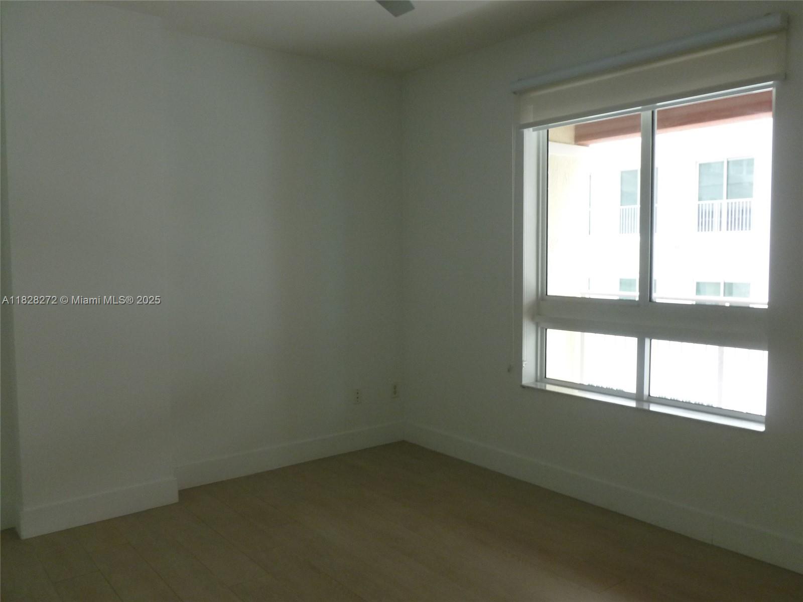 7350 Southwest 89th Street, Unit 808S Miami, FL 33156 - Photo 8 of 13 an empty room with a window