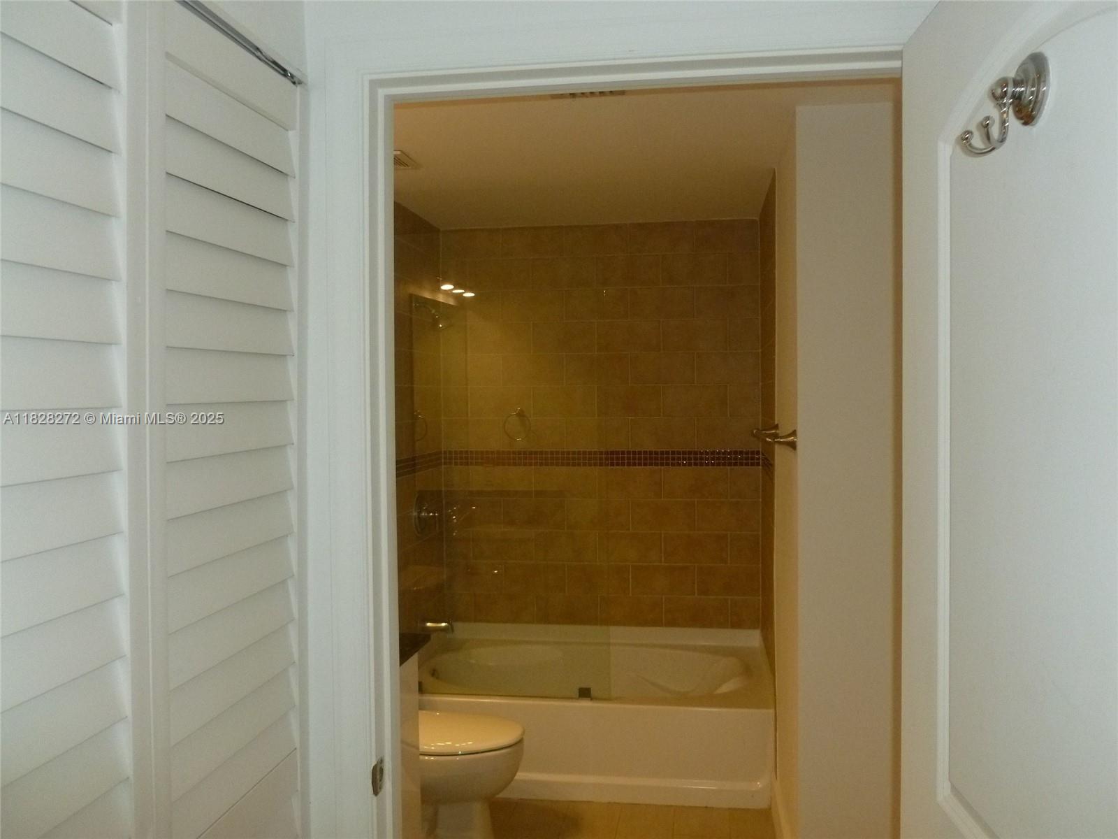 7350 Southwest 89th Street, Unit 808S Miami, FL 33156 - Photo 9 of 13 a bathroom with a glass shower door