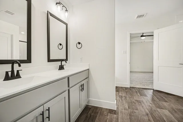 a bathroom with a double vanity sink and mirror