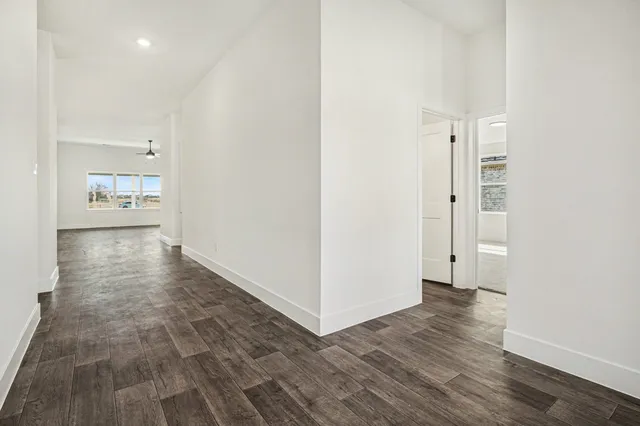 a view of a hallway with wooden floor