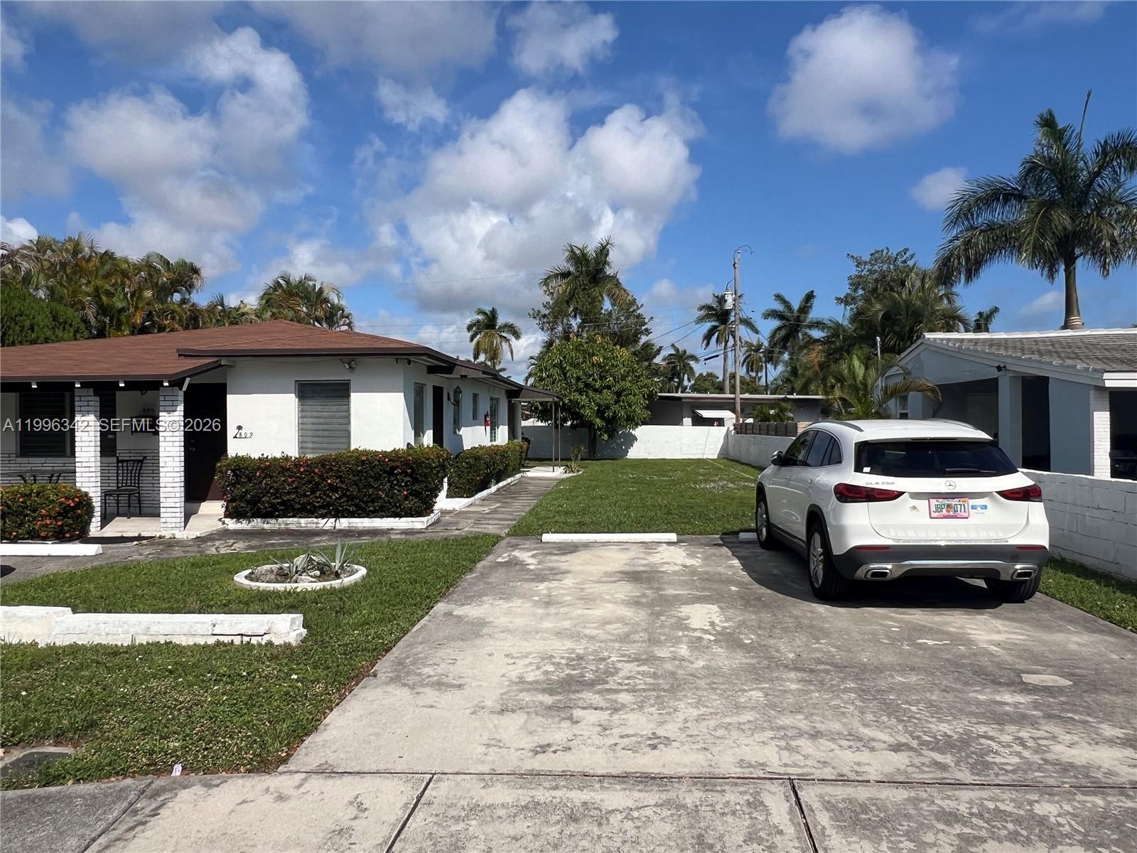 809 Northeast 2nd Street, Unit 2 Hallandale Beach, FL 33009 - Photo 3 of 8 a view of a house with a yard