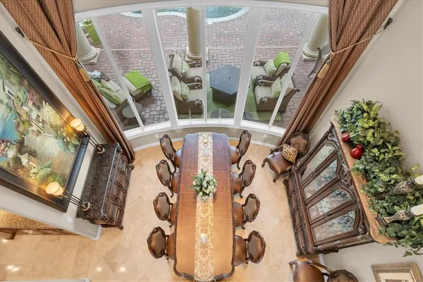 a room with pool table and windows
