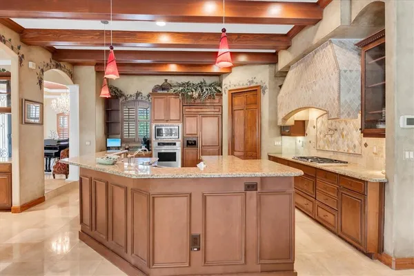a kitchen with stainless steel appliances granite countertop a stove and a sink