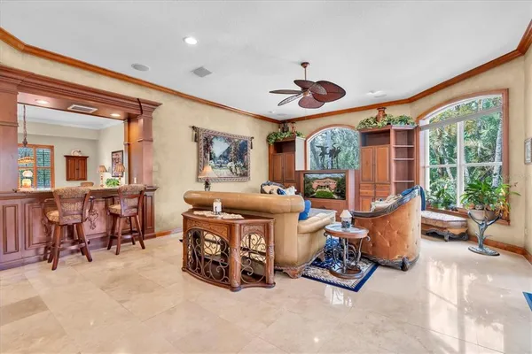 a living room with furniture and a potted plant