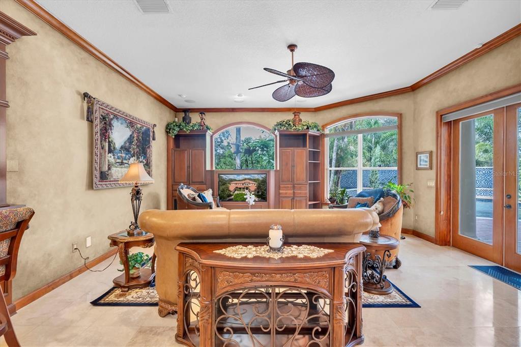 2861 Roehampton Close Tarpon Springs, FL 34688 - Photo 23 of 84 a living room with furniture and a large window