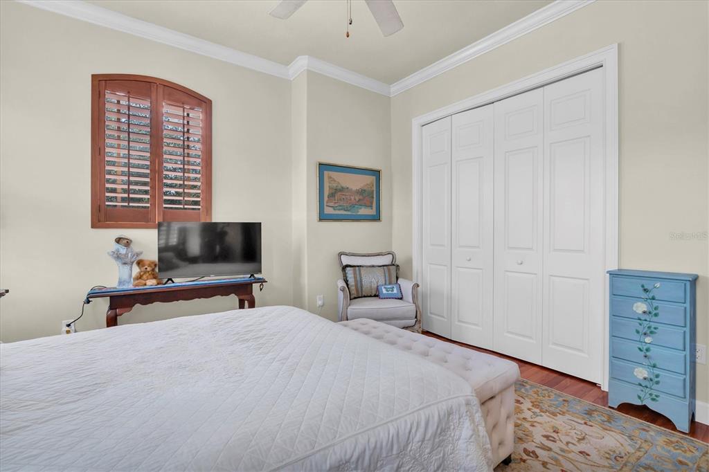 2861 Roehampton Close Tarpon Springs, FL 34688 - Photo 53 of 84 a bedroom with a bed and a flat tv screen