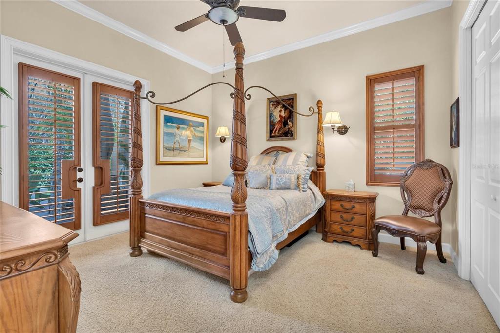 2861 Roehampton Close Tarpon Springs, FL 34688 - Photo 60 of 84 a bedroom with a bed and a chandelier