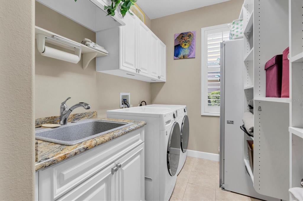 2861 Roehampton Close Tarpon Springs, FL 34688 - Photo 63 of 84 a utility room with sink dryer and washer