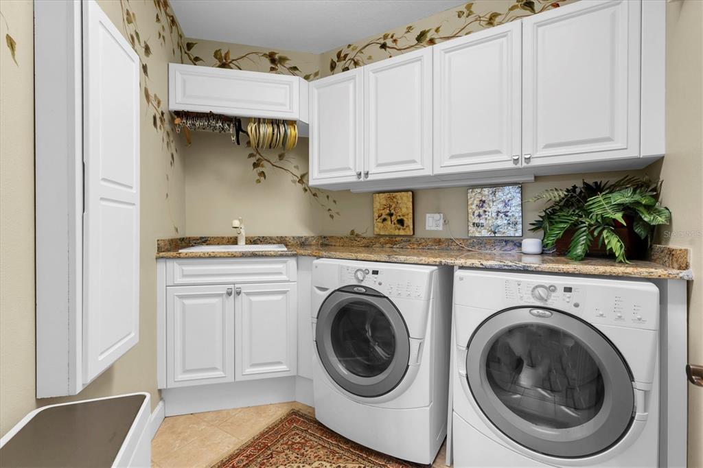 2861 Roehampton Close Tarpon Springs, FL 34688 - Photo 64 of 84 a utility room with sink dryer and washer